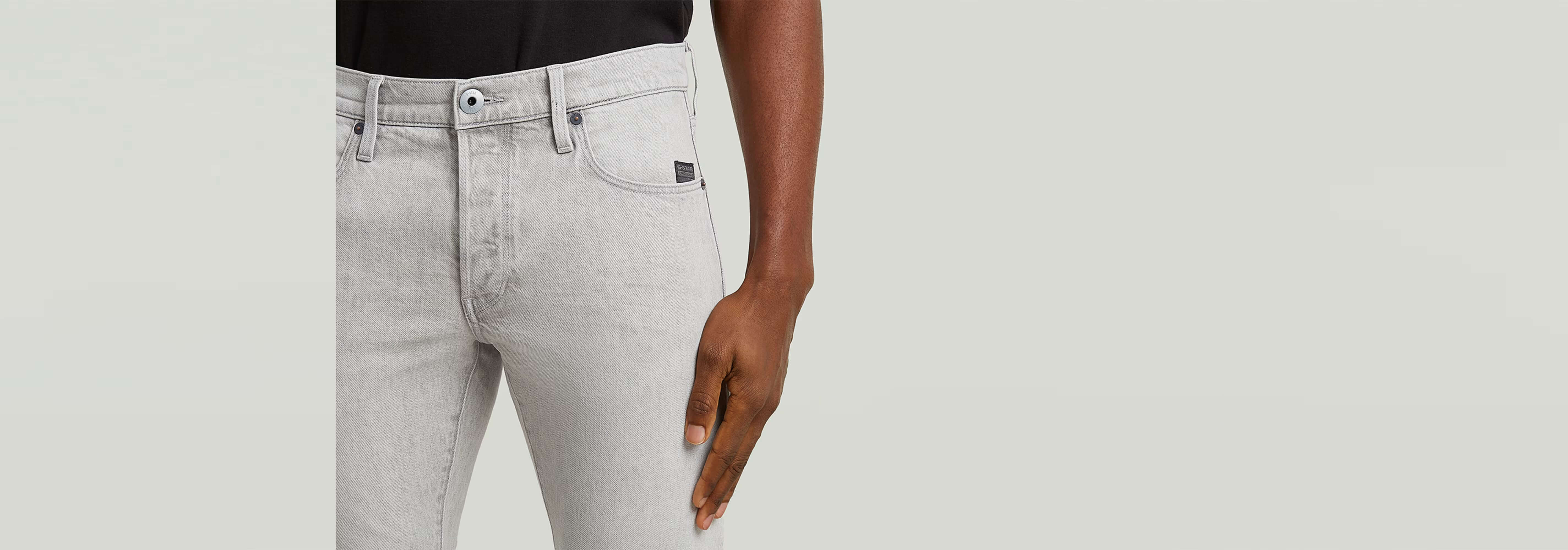 Jeans 3301 Slim mostrando corte ajustado en color gris claro, con diseño clásico y cinco bolsillos.