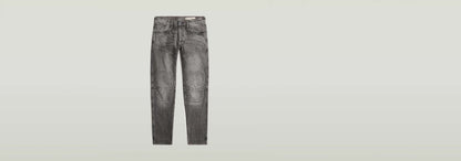 Jeans Biker Patched Slim en color gris con diseño 3D y parches, corte ajustado y rodillas articuladas.