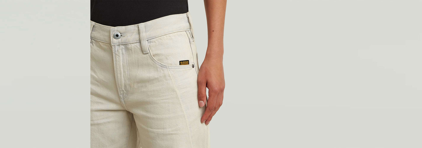 Jeans Contor Barrel Loose, detalle de la mano sobre el bolsillo de los jeans, color claro, construcción 3D.