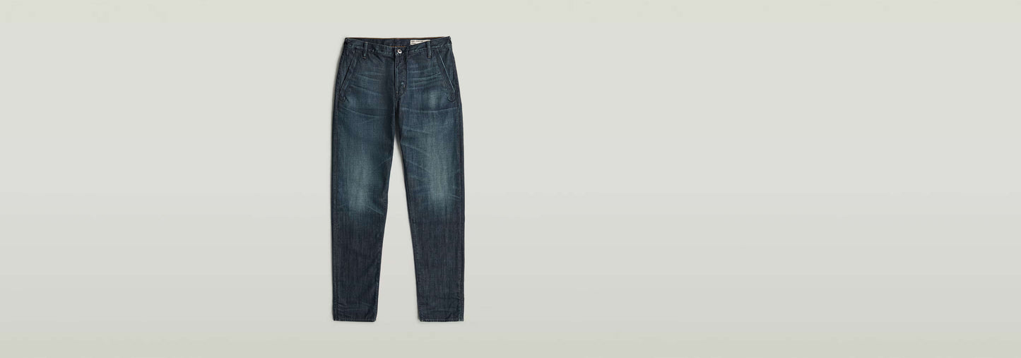 Pantalones chinos Morry Tapered en denim greencast, ajuste cónico y acabado índigo con matiz verde.