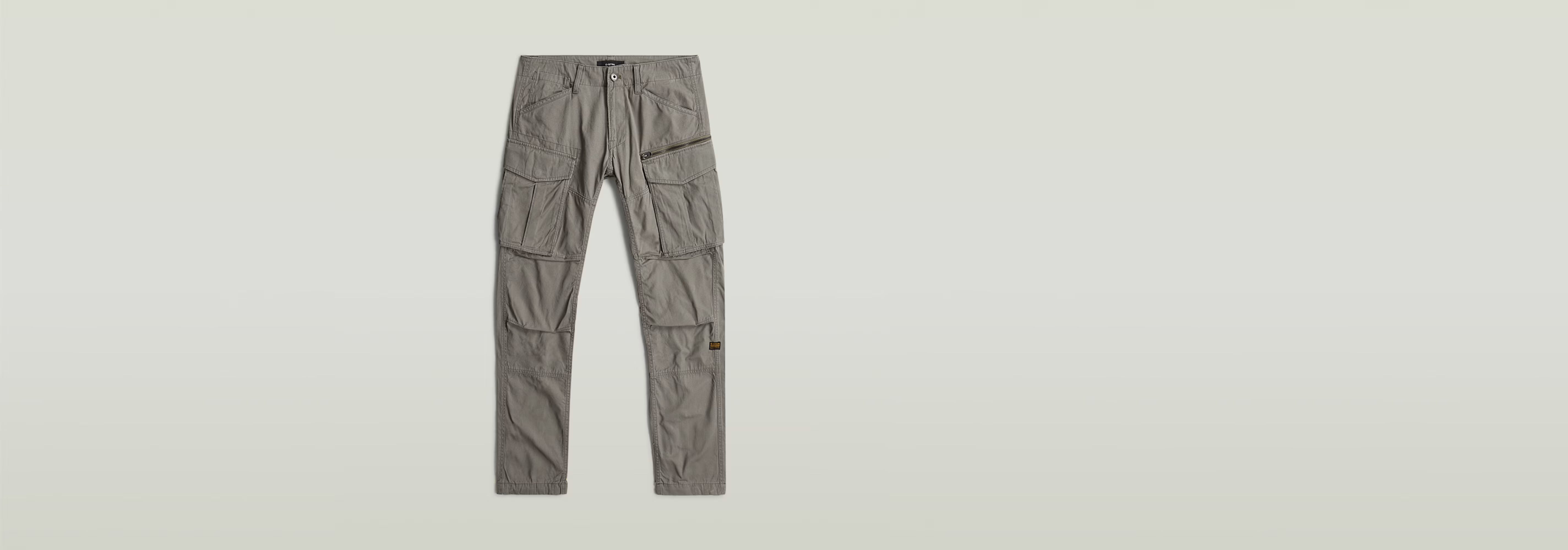 Pantalones Rovic Zip 3D Regular Tapered con cierre de cremallera y botones, diseño adaptable y varios bolsillos.
