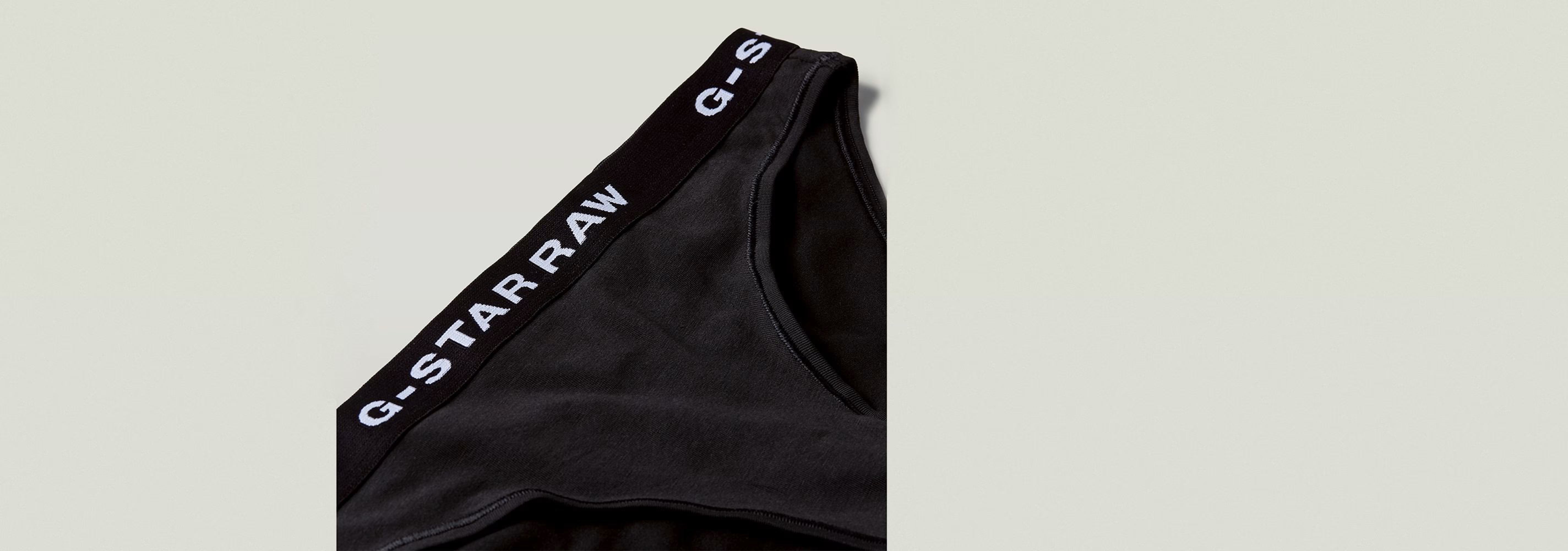 Paquete De Tres Braguitas de G-Star RAW, mostrando la cinturilla elástica con logotipo en color negro.