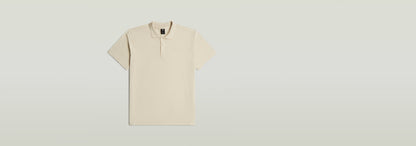 Polo Core Regular en color beige, con diseño clásico de polo y cierre de botones, fabricado en 100% algodón ecológico.