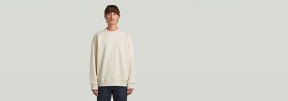 Sudadera GS-01 Relaxed en color claro, corte relajado, cuello redondo y manga larga, 100% algodón ecológico.