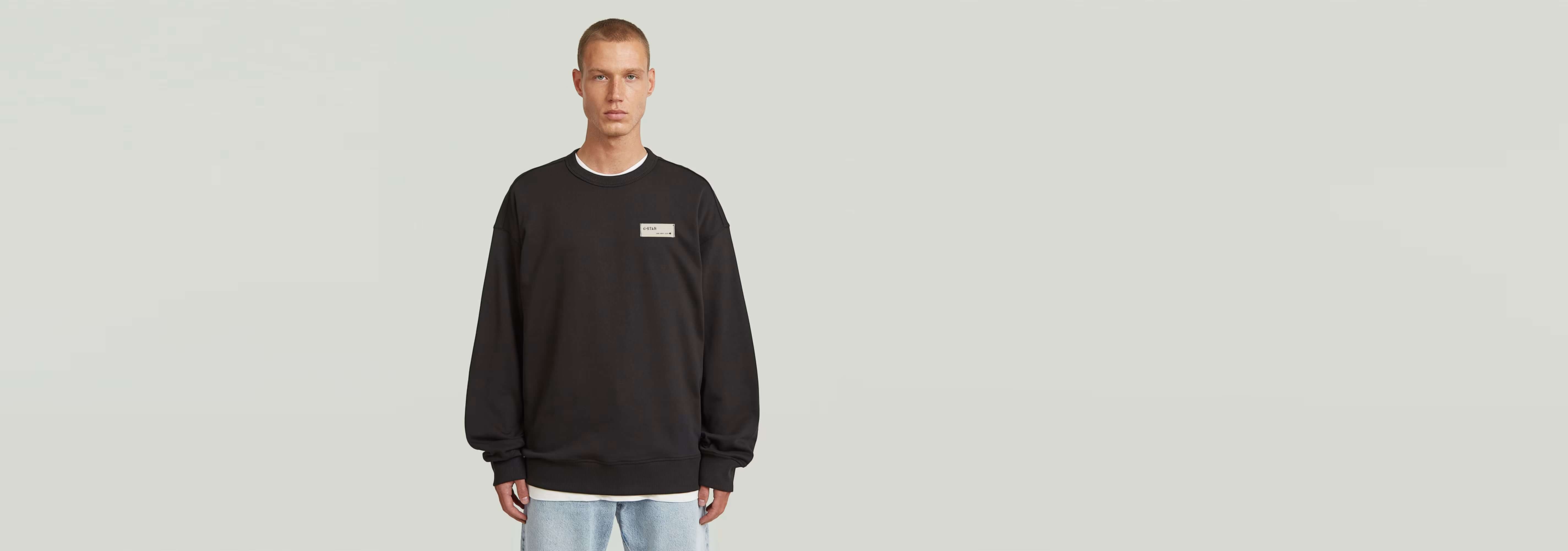 Sudadera HB Badge en color negro con diseño atractivo y corte relajado, ideal para cualquier armario.