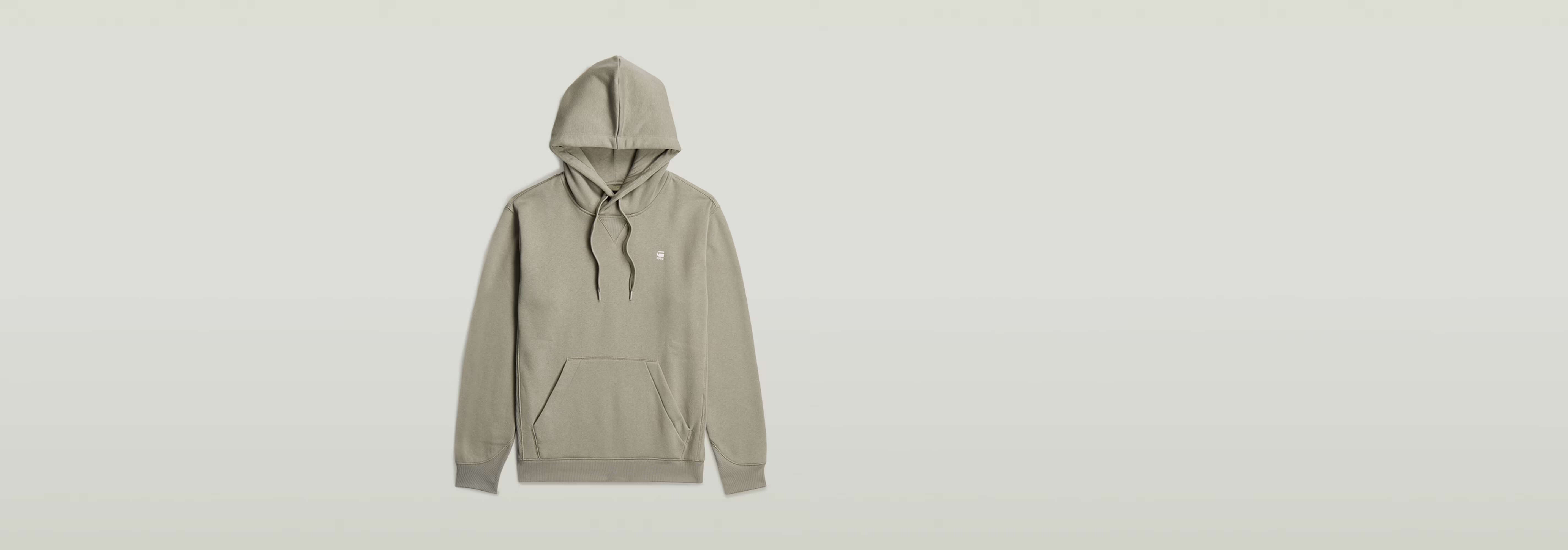 Sudadera Premium Core Hoodie de color beige con capucha y bolsillos frontales.