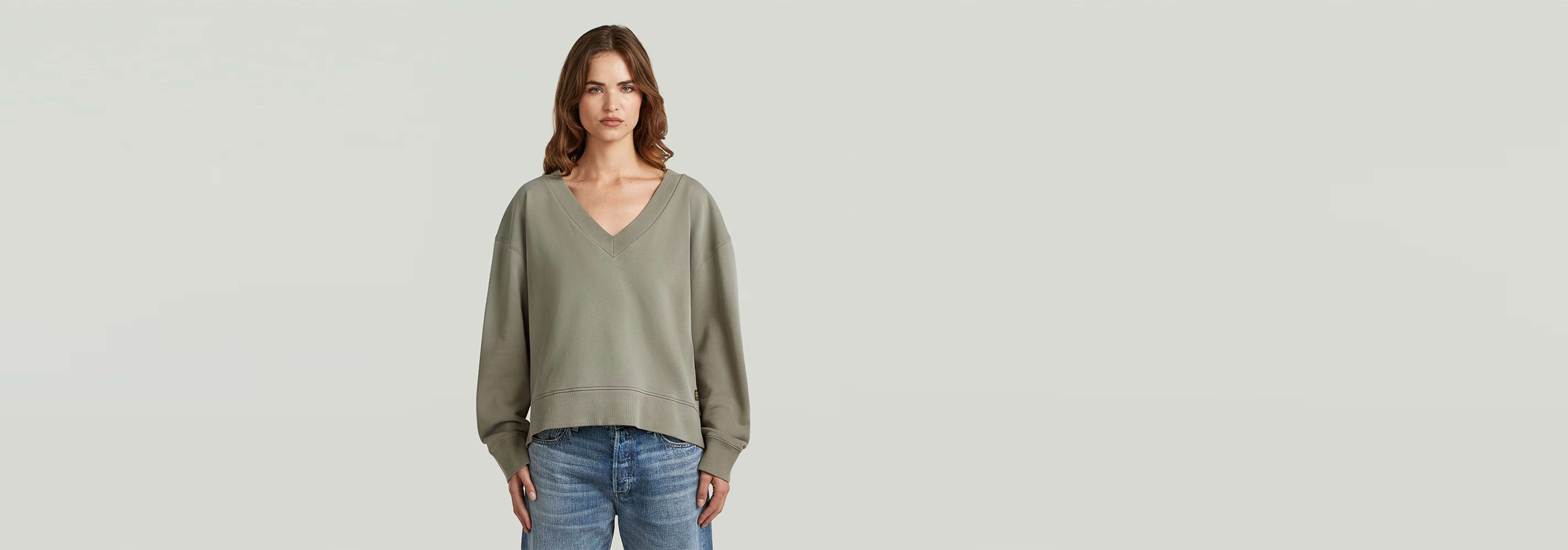 Suéter Sunfaded V-Neck Loose en color gris, con cuello de pico y manga larga, estilo relajado y efecto descolorido.