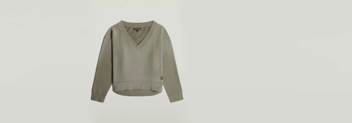 Suéter Sunfaded V-Neck Loose en color gris, con corte relajado y cuello de pico, manga larga y diseño descolorido por el sol.