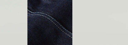 Close-up of Top Kick Bustier fabric with dark denim texture and contrasting white stitching details.