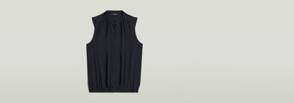Top sin mangas Stand Up Collar en color negro con cuello mao y diseño sin mangas.